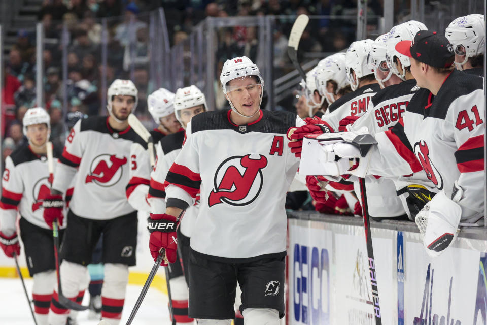 New Jersey Devils left wing Ondrej Palat (18) is congratulated for his goal against the Seattle Kraken during the first period of an NHL hockey game Thursday, Dec. 7, 2023, in Seattle. (AP Photo/Jason Redmond)