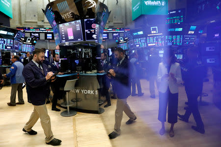 FILE PHOTO: Traders work on the floor of the New York Stock Exchange (NYSE) in New York, U.S., September 18, 2018. REUTERS/Brendan McDermid/File Photo