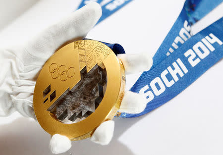A gold medal manufactured for the 2014 Winter Olympic Games in Sochi, is seen on display at the Adamas jewellery factory in Moscow, June 28, 2013. REUTERS/Sergei Karpukhin/File Photo