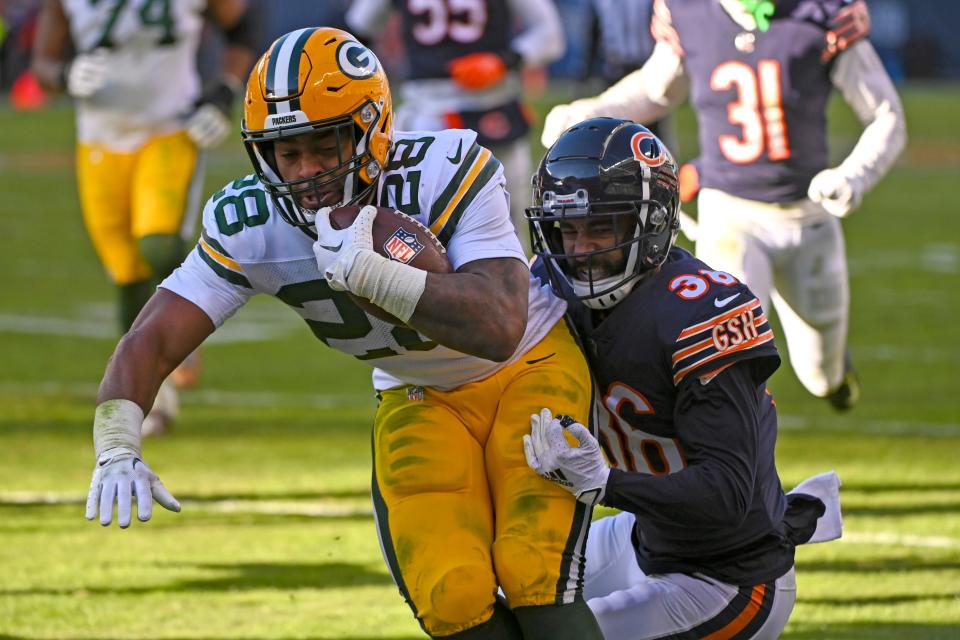 Packers running back AJ Dillon scores a touchdown past Bears safety DeAndre Houston-Carson during the second half of their Week 13 game at Soldier Field.