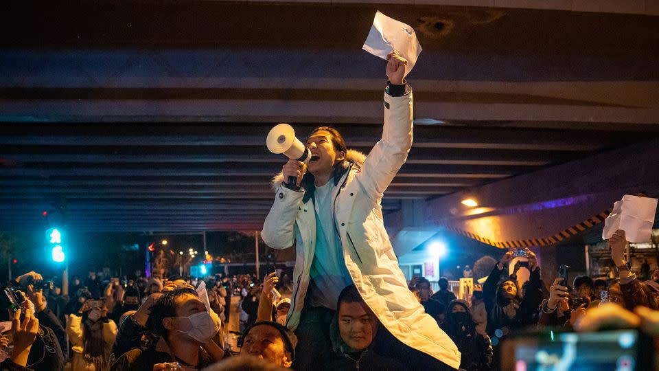 A demonstrator holds a blank sign and chants slogans during a protest in Beijing on November 28, 2022. - Stringer/Bloomberg/Getty Images