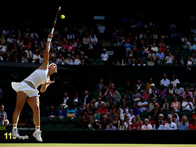 Sabine Lisicki of Germany serves during the Ladies' Singles third round match against Samantha Stosur of Australia on day six of the Wimbledon Lawn Tennis Championships at the All England Lawn Tennis and Croquet Club on June 29, 2013 in London, England.