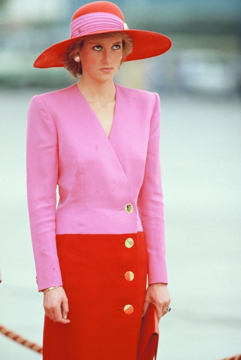 <p>Princess Diana in a pink-and-red Catherine Walker dress and a matching Philip Somerville hat on an official visit to Kuwait. </p>