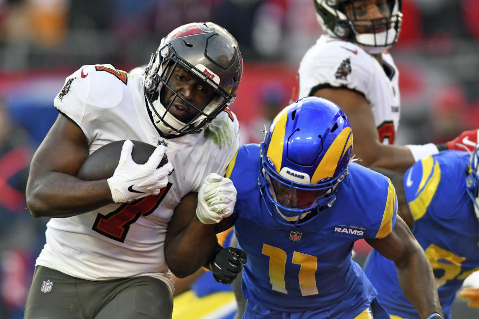 Tampa Bay Buccaneers running back Leonard Fournette (7) gets by Los Angeles Rams cornerback Darious Williams (11) to score during the second half of an NFL divisional round playoff football game Sunday, Jan. 23, 2022, in Tampa, Fla. (AP Photo/Jason Behnken)