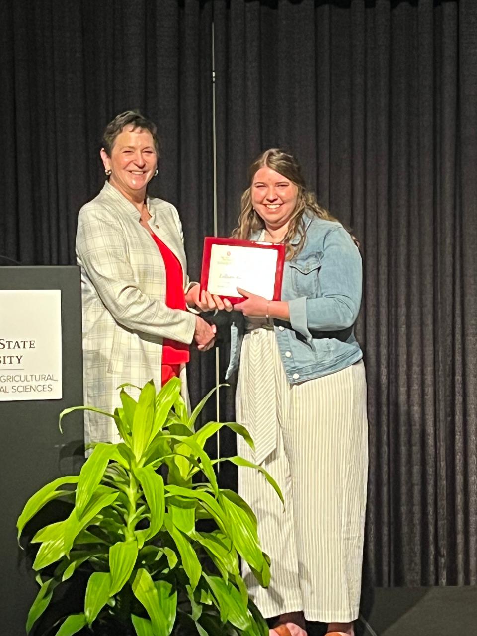 Dr. Kris Boone, director of Ohio State ATI and assistant dean of the College of Food, Agricultural, and Environmental Sciences (left), presents the 2023 Director’s Award to Lillian Wagner.