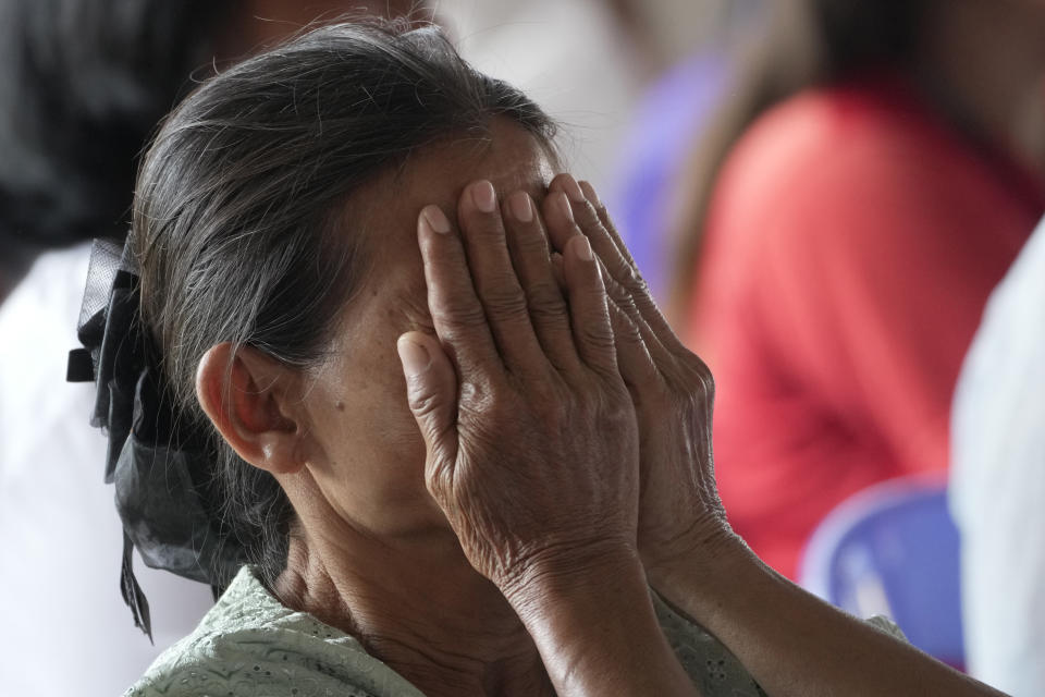 A relative of a victim cry during the Buddhist ceremony in the rural town of Uthai Sawan, in Nong Bua Lamphu province northeastern Thailand, Friday, Oct. 6, 2023. A memorial service takes place to remember those who were killed in a grisly gun and knife attack at a childcare center. A former police officer killed 36 children and teachers in the deadliest rampage in Thailand's history one year ago. (AP Photo/Sakchai Lalit)