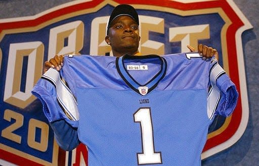 Charles Rogers holds up a Detroit Lions jersey after being selected second overall in the 2003 NFL draft.