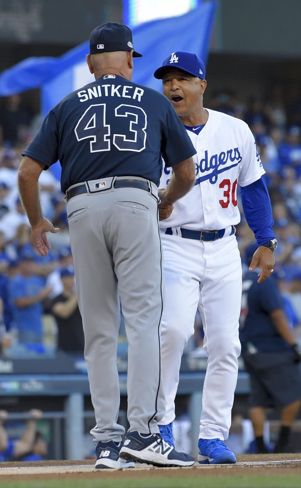 Los Angeles Dodgers manager Dave Roberts, right, greets Atlanta Braves manager Brian Snitker before Game 1 of a baseball National League Division Series, Thursday, Oct. 4, 2018, in Los Angeles. (AP Photo/Mark J. Terrill)