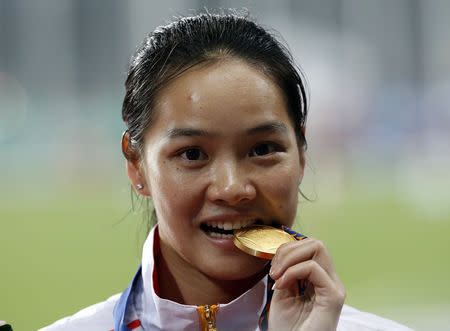 China's Wei Yongli poses with her medal at the award ceremony for the women's 100m final at the Incheon Asiad Main Stadium during the 17th Asian Games September 28, 2014. REUTERS/Kim Kyung-Hoon