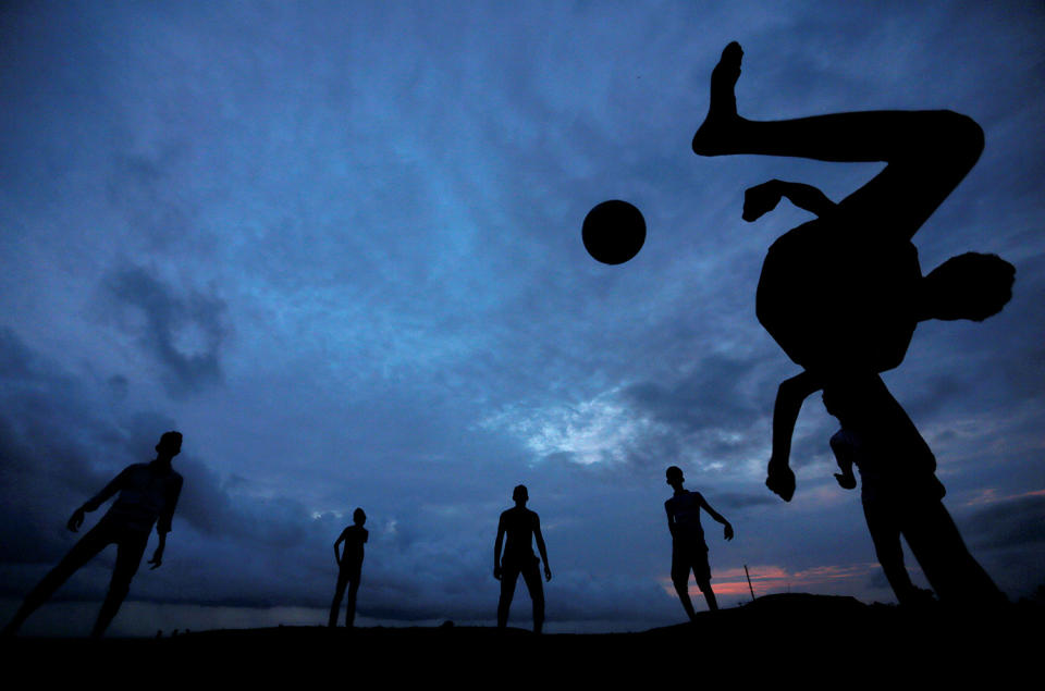 <p>A boy kicks a ball as he plays soccer with his friends at Galle Dutch Fort in Galle, Sri Lanka May 19, 2017. (Photo: Dinuka Liyanawatte/Reuters) </p>