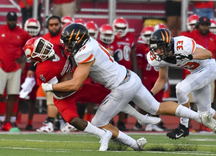 Brody Foley of Anderson tackles T.J. Engleman of Princeton during the Skyline Crosstown Showdown on Friday, Aug. 19, 2021.