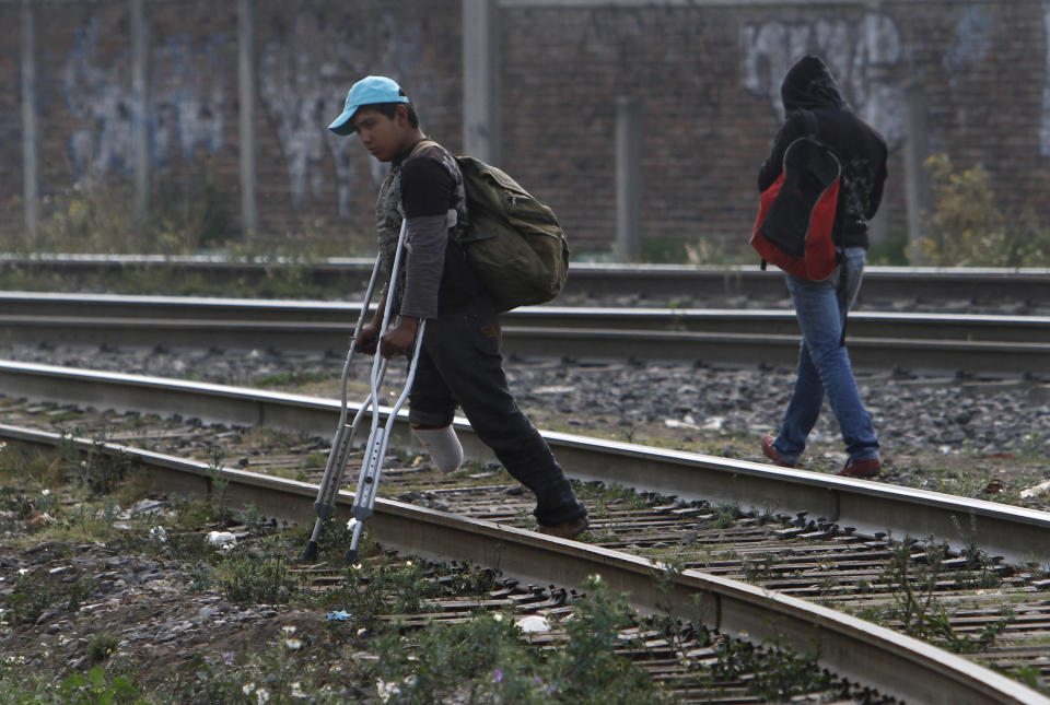 In this May 12, 2012 photo, a Central American migrant, who lost a leg when he fell from a train, walks on crutches along the tracks while waiting for a train to continue his journey to the US-Mexico border, in Lecheria, on the outskirts of Mexico City. While the number of Mexicans heading to the U.S. has dropped dramatically, a surge of Central American migrants is making the 1,000-mile northbound journey this year, fueled in large part by the rising violence brought by the spread of Mexican drug cartels. (AP Photo/Marco Ugarte)