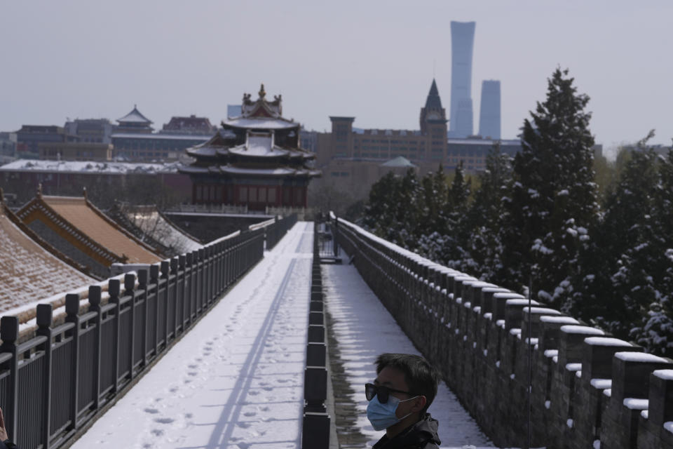 A security guard stands near the wall of the Forbidden City on Saturday, March 19, 2022, in Beijing. China's national health authorities reported two COVID-19 deaths on Saturday, the first recorded rise in the death toll since January 2021, as the country battles an omicron-driven surge. (AP Photo/Ng Han Guan)