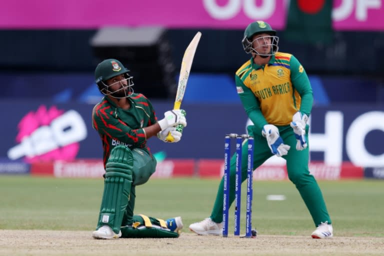 Big hitter: Towhid Hridoy of Bangladesh plays a shot while Quinton de Kock looks on (ROBERT CIANFLONE)