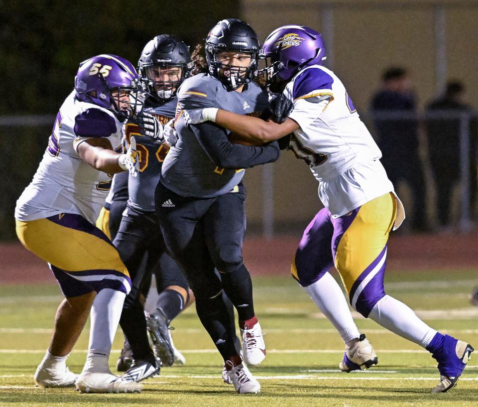 Tulare Union's Dominic Wilson tries to escape Lemoore's Theodore Sanchez in a West Yosemite League high school football game Thursday, September 28, 2023.