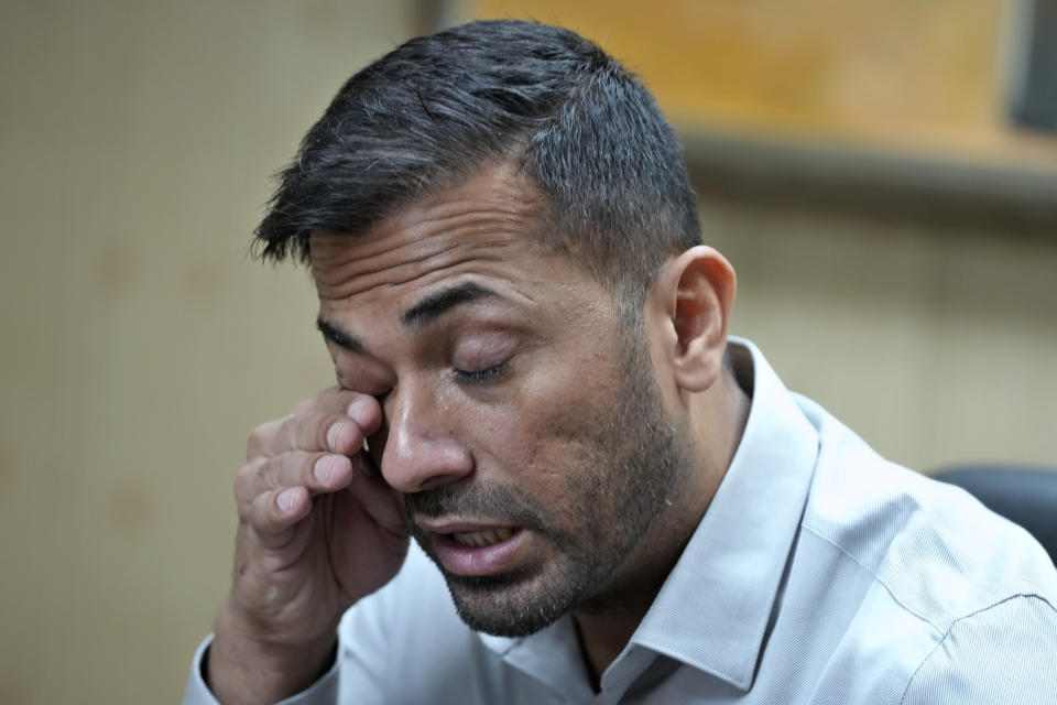Pakistan fast bowler Wahab Riaz wipes his tears during a press conference, in Lahore, Pakistan, Wednesday, Aug. 16, 2023. Riaz retired from international cricket on Wednesday but will continue to play franchise cricket. (AP Photo/K.M. Chaudary)