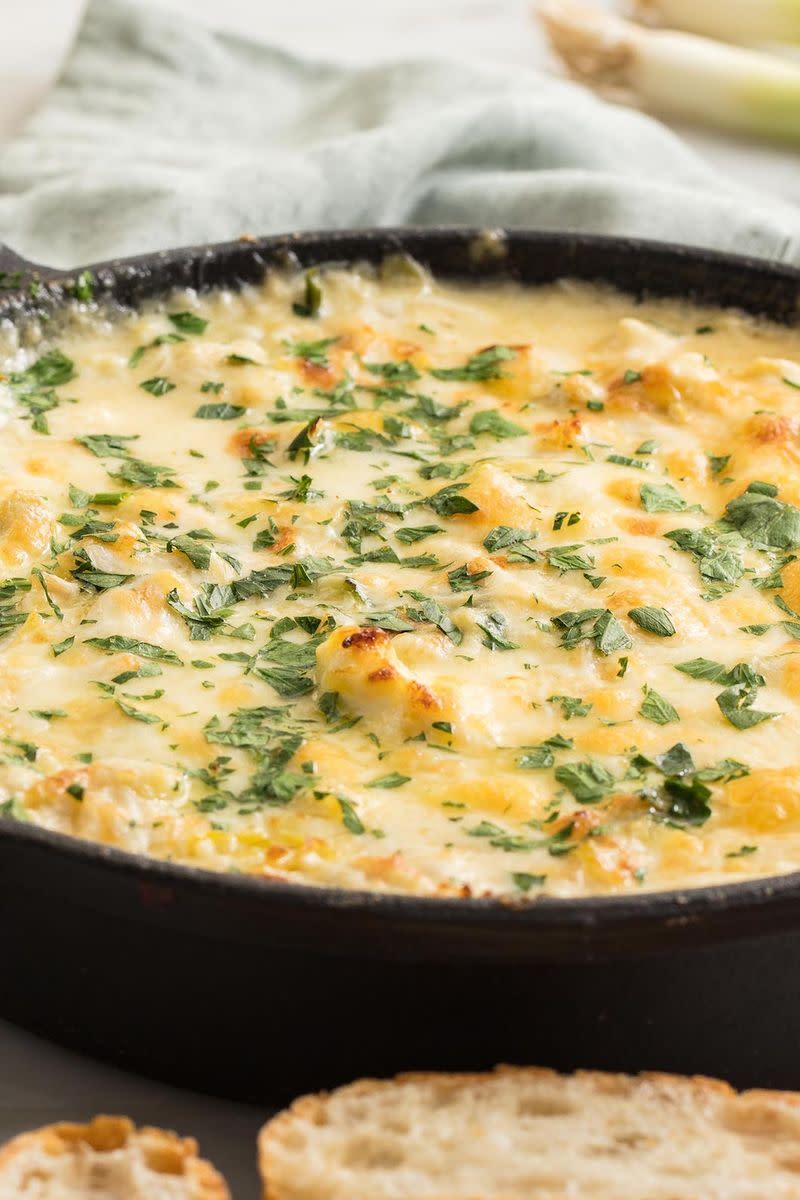 <p>When hosting a party, a hot and cheesy dip is absolutely necessary in our opinion. This one's classy AF but comes together in just 35 minutes—which is no time at all considering the biggest hunk of time is dedicated to the skillet baking and you relaxing. </p><p>Get the <a href="http://www.delish.com/uk/cooking/recipes/a32978145/crab-artichoke-dip-recipe/" rel="nofollow noopener" target="_blank" data-ylk="slk:Crab Artichoke Dip;elm:context_link;itc:0;sec:content-canvas" class="link ">Crab Artichoke Dip</a> recipe.</p>
