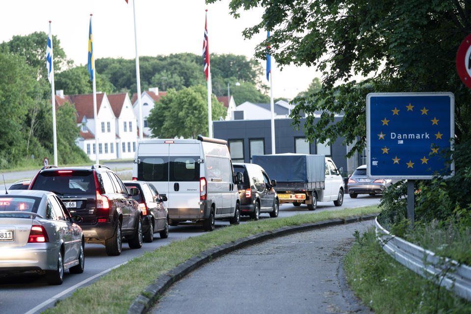 Vehicles queue at the border crossing in Krusaa, Denmark, after Denmark reopened its borders to Germany, Monday morning, June 15, 2020, following the new coronavirus pandemic. (Claus Fisker/Ritzau Scanpix via AP)