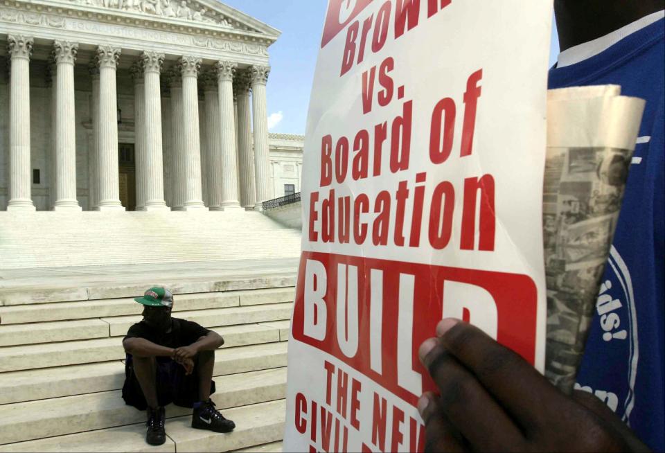 Activists organized by By Any Means Necessary rally in front of the U.S. Supreme Court to mark the anniversary of the Brown v. Board of Education decision May 15, 2004, in Washington, D.C.