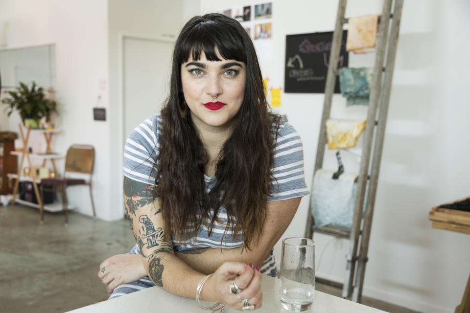 Pictured: Young woman with tattoos on arm. Image: Getty