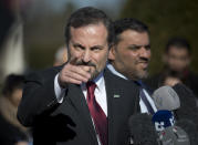 Louay Safi, center, spokesperson for the Syrian National Coalition, Syria's main political opposition group, points to a journalist during a press briefing at the United Nations headquarters in Geneva, Switzerland, Switzerland, Wednesday, Feb 12, 2014. Russian Deputy Minister of Foreign Affairs Gennady Gatilov arrived in Geneva and met with U.N. mediator Lakhdar Brahimi who was pessimistic over any progress at the talks. (AP Photo/Anja Niedringhaus)