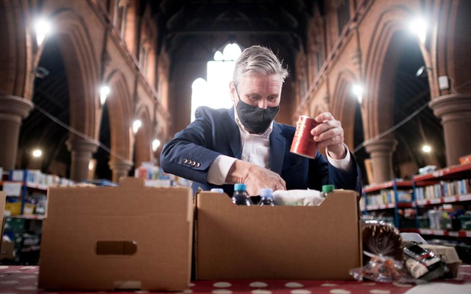 Saint Keir: Labour leader visits a food bank distribution centre in St Margaret The Queen church in Streatham - Reuters