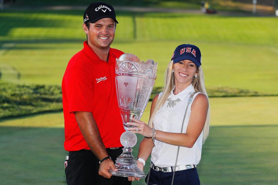 Patrick Reed poses with his wife Justine and the trophy after winning The Barclays in the PGA Tour FedExCup Play-Offs on the Black Course at Bethpage State Park on August 28, 2016 in Farmingdale, New York