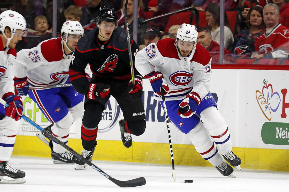 Montreal Canadiens' Victor Mete (53) brings the puck up the ice after taking it away from Carolina Hurricanes' Martin Necas (88), of the Czech Republic, during the first period of an NHL hockey game in Raleigh, N.C., Tuesday, Dec. 31, 2019. (AP Photo/Karl B DeBlaker)
