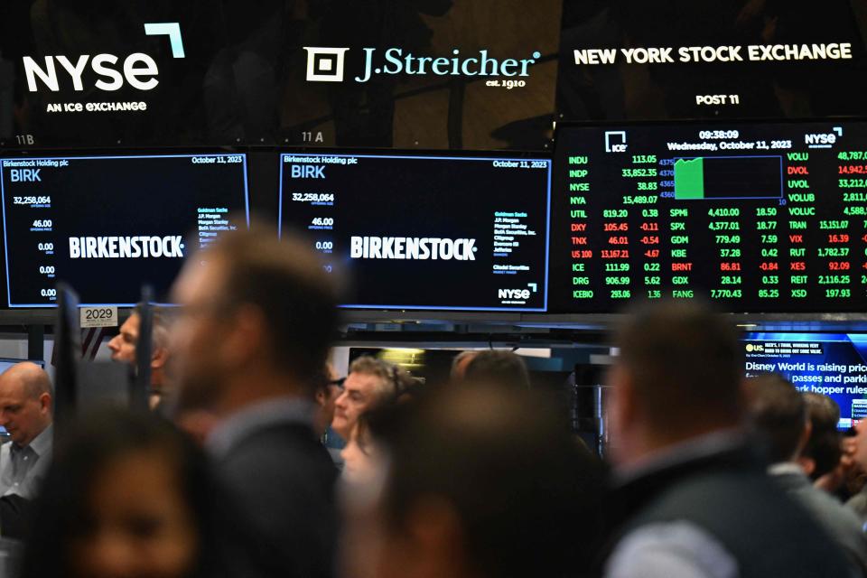 Traders works the floors at the New York Stock Exchange (NYSE) in New York on October 11, 2023, during Birkenstock's launch of an Initial Public Offering (IPO). German sandals maker Birkenstock's IPO launch values the company at $8.6 billion, according to multiple media reports.