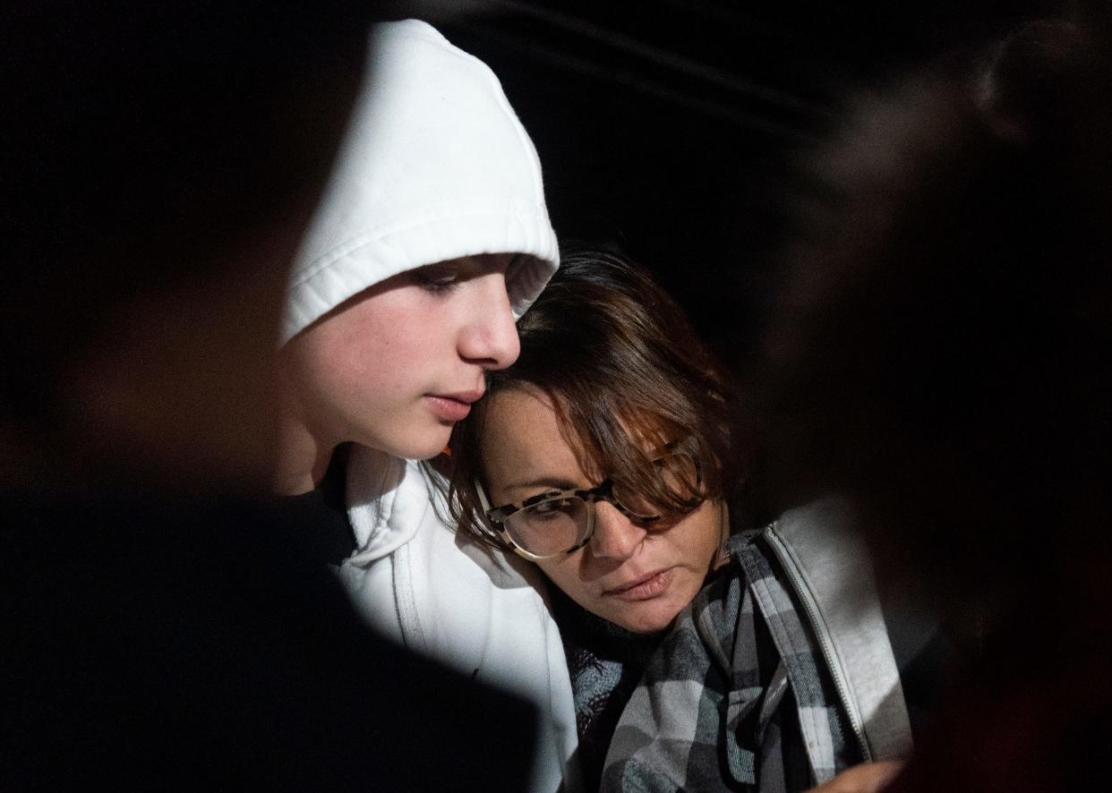 Peter Romano's twin brother Nick (14) and mother, Elaine Romano listen to Maria Romano, Peter's sister, read her speech to the press during the vigil for him at 2636 Bristol Pike in Bensalem on Thursday, Nov. 2, 2023.

[Daniella Heminghaus | Bucks County Courier Times]