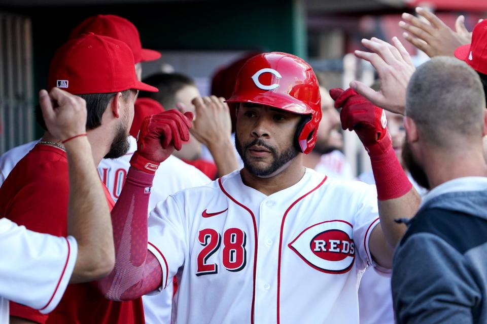 Cincinnati Reds left fielder Tommy Pham (28) is congratulated in the dugout after hitting a two-run home run in the first inning of a baseball game against the Washington Nationals, Friday, June 3, 2022, at Great American Ball Park in Cincinnati. 