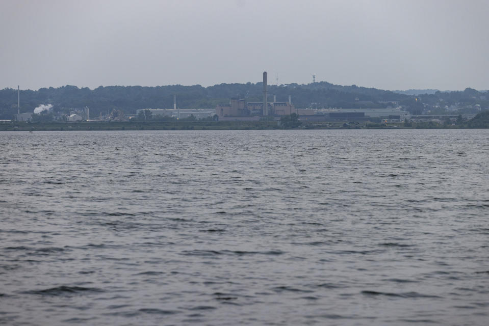 Industrial buildings sit on the shores of Onondaga Lake, Thursday, Aug. 3, 2023, in Syracuse, N.Y. (AP Photo/Lauren Petracca)