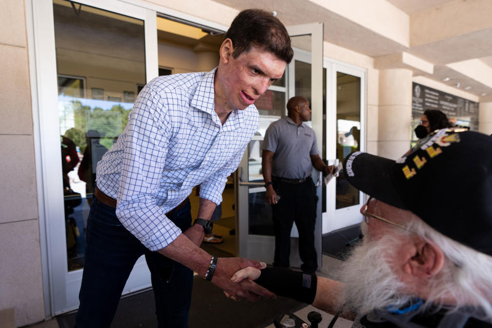 Brown shakes hands with a veteran at the Memorial Day Ceremony at the Southern Nevada Veterans Memorial Cemetery in Boulder City on May 30.<span class="copyright">Bill Clark—CQ-Roll Call/Getty Images</span>