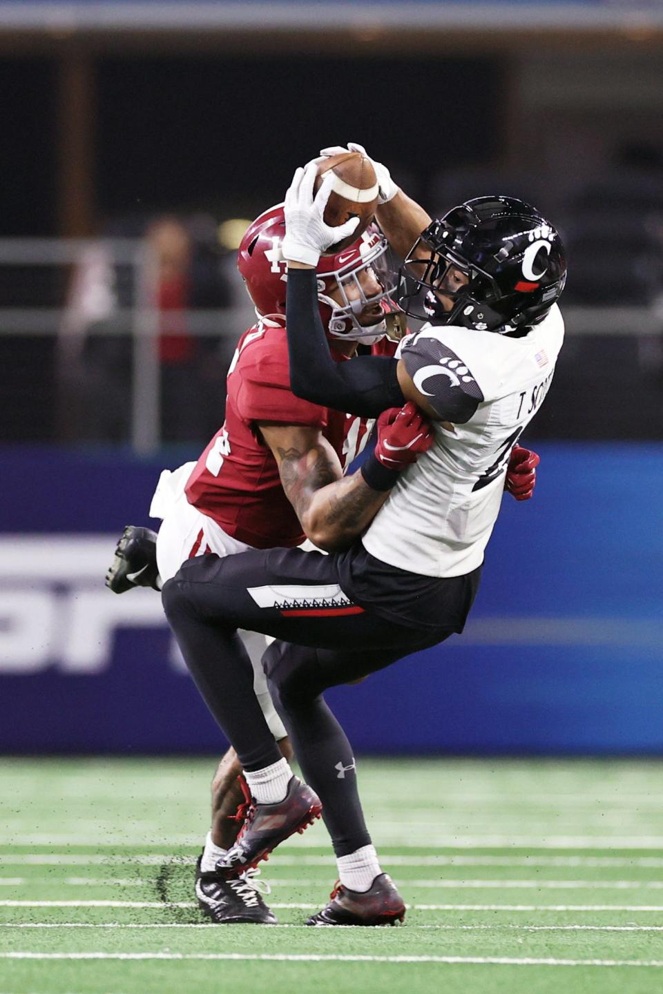 Cincinnati wide receiver Tyler Scott is tackled by Alabama  defensive back Brian Branch.