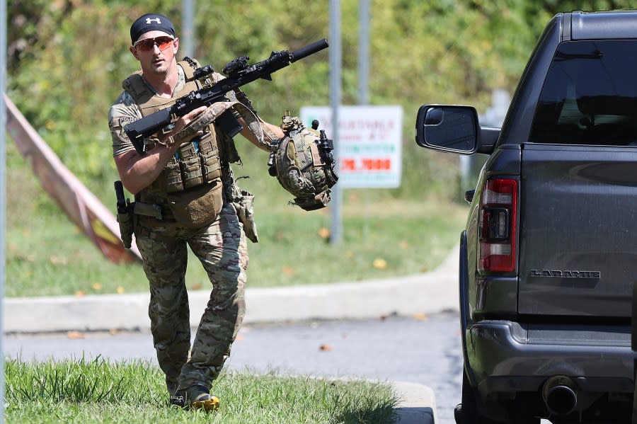 A heavily armed law enforcement officer runs on a potential sighting of Danelo Cavalcante in Pocopson Township, Pa. on Sunday, Sept. 3, 2023. Cavalcante escaped from the Chester County Prison last Thursday. (David Maialetti/The Philadelphia Inquirer via AP)