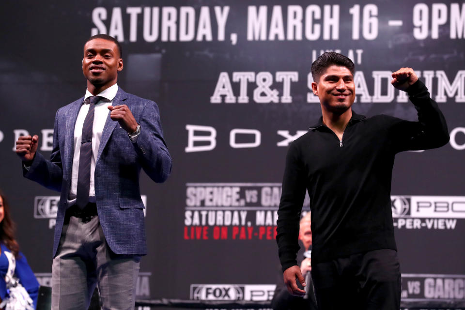 LOS ANGELES, CALIFORNIA - FEBRUARY 16: Errol Spence and Mikey Garcia wave to the crowd during the Errol Spence v Mikey Garcia Press Conference at Microsoft Theater on February 16, 2019 in Los Angeles, California. (Photo by Joe Scarnici/Getty Images)