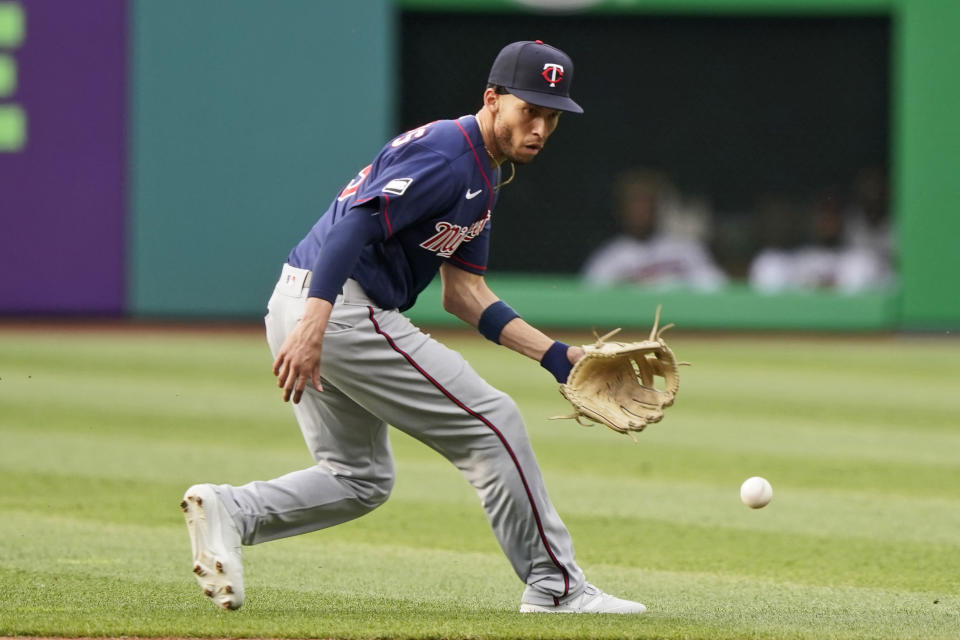 Minnesota Twins' Andrelton Simmons fields a ball hit by Cleveland Indians' Eddie Rosario in the first inning of a baseball game, Friday, May 21, 2021, in Cleveland. Rosario was out on the play. (AP Photo/Tony Dejak)