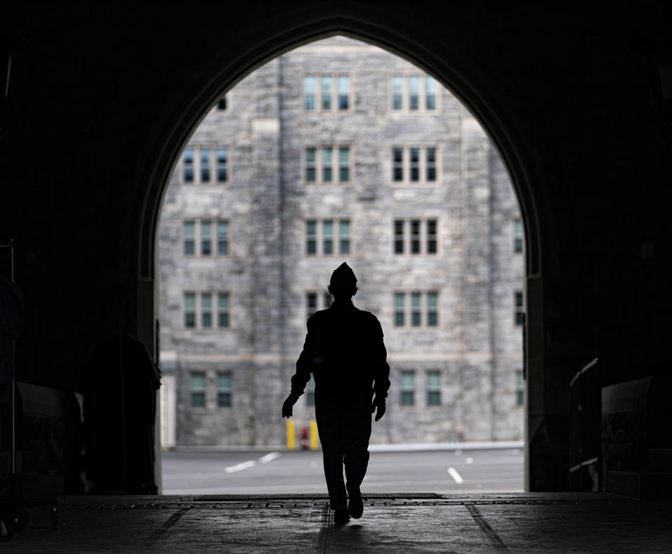 A cadet walks through campus at the United States Military Academy in West Point, N.Y., Wednesday, Nov. 29, 2023. (AP Photo/Peter K. Afriyie)