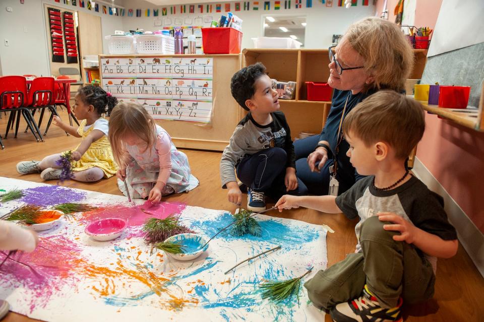 Tammy Plaza, lead teacher for the "Cardinals" at the MetroWest YMCA Preschool, leads a painting activity with, from left, Rose Pierre-Louis, Elise Eiler, Anthony Siquiera and Jameson Goncalves.