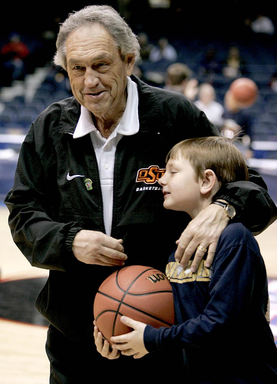 Oklahoma State coach Eddie Sutton hugs his grandson Spencer at practice for the NCAA Tournament in Chicago in 2005. Sixteen years later, Spencer is a 23-year-old high school coach just like Eddie was to start his legendary career.