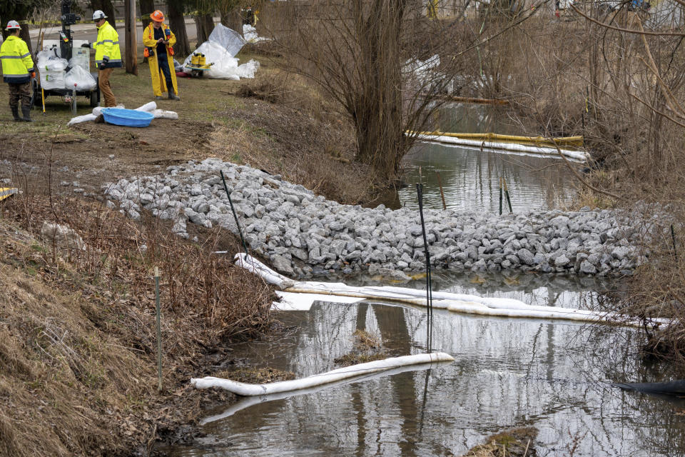 Cleanup continues in a stream in East Palestine Park in East Palestine, Ohio, Thursday, Feb. 16, 2023. Residents of the Ohio village upended by a freight train derailment are demanding to know if they're safe from the toxic chemicals that spilled or were burned off to avoid an even bigger disaster. (Lucy Schaly/Pittsburgh Post-Gazette via AP)