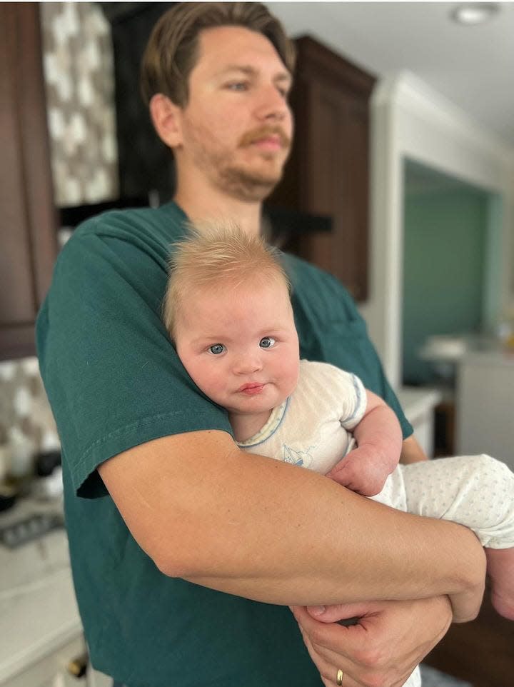 Adam Hohne holds his son, August, who was born with 5p- last summer.