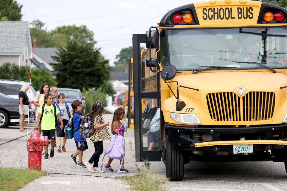 Maple Street Magnet School students board the bus after their first day of school Monday, Aug. 9, 2021, in Rochester.