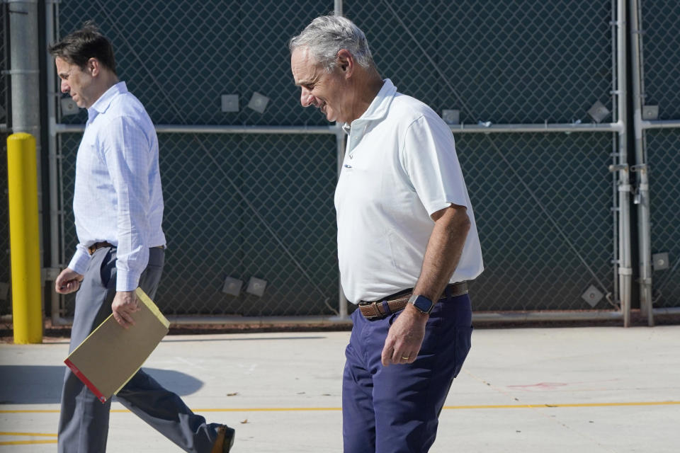 Major League Baseball Deputy Commissioner Dan Halem, left, and Commissioner Rob Manfred, right, walk after negotiations with the players association in an attempt to reach an agreement to salvage March 31 openers and a 162-game season, Monday, Feb. 28, 2022, at Roger Dean Stadium in Jupiter, Fla. (AP Photo/Lynne Sladky)