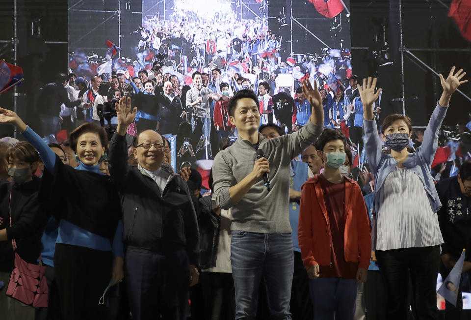 Taiwan Kuomintang party Taipei city mayoral candidate Wayne Chiang and his families celebrate Chiang's victory with supporters in Taipei, Taiwan, Saturday, Nov. 26, 2022. Lingering concerns about the threat posed by its giant neighbor China took a backseat in Taiwan''s closely watched local elections on Saturday as voters focused on other pressing issues closer to home such as air pollution and bad traffic. (AP Photo/Chiang Ying-ying)