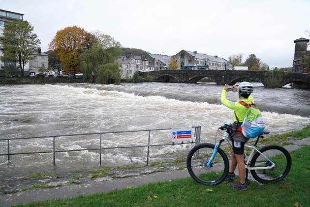 The River Kent was surging in Kendal (Owen Humphreys/PA)