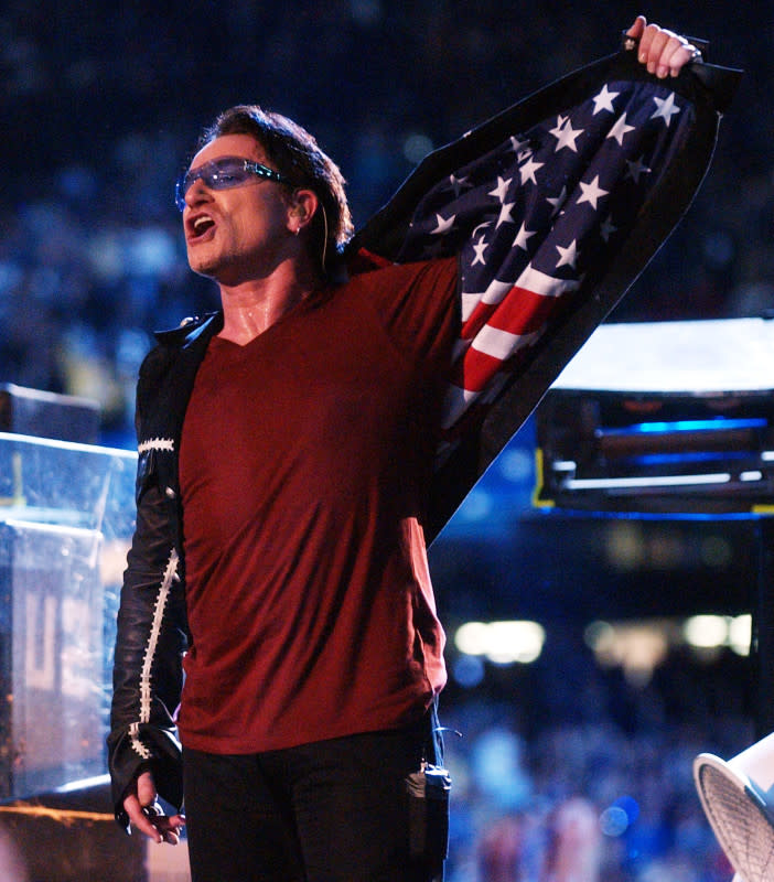 Bono, lead singer of U2, shows an American flag lining in his jacket during the halftime show at Super Bowl XXXVI in the Superdome, New Orleans on Feb. 3, 2002.<p>KMazur/Getty Images</p>