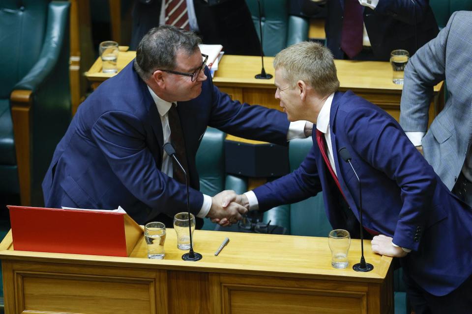 Prime Minister Chris Hipkins congratulates Minister of Finance Grant Robertson after the budget address. Hagen Hopkins/Getty Images