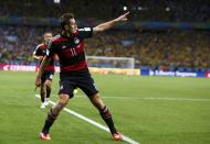 Germany's Miroslav Klose celebrates after scoring a goal during the 2014 World Cup semi-finals between Brazil and Germany at the Mineirao stadium in Belo Horizonte July 8, 2014. REUTERS/Marcos Brindicci (BRAZIL - Tags: TPX IMAGES OF THE DAY SOCCER SPORT WORLD CUP)