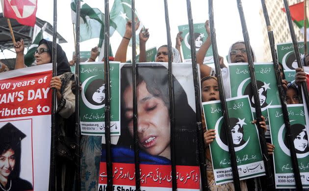 Pakistani protesters from the hard-line Sunni group Pasban hold portraits of Pakistani scientist Aafia Siddiqui during a demonstration marking International Women's Day on March 8, 2011. Siddiqui was sentenced to 86 years in jail by a U.S. court who found her guilty of the attempted murder of U.S. military officers in Afghanistan in 2008. (Photo: Rizwan Tabassum/AFP via Getty Images)